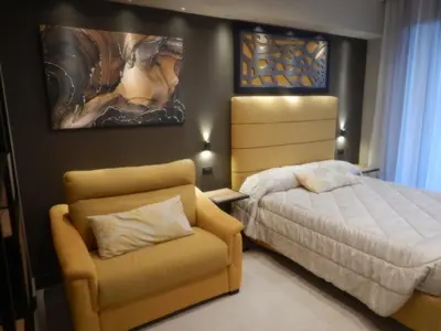 a bedroom with a bed and a chair at Domus Aurelia Studio Apartments in Rome
