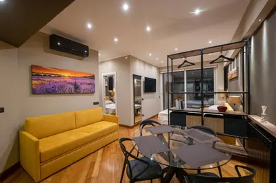 a living room with a yellow couch and a table at Domus Aurelia Luxury in Rome