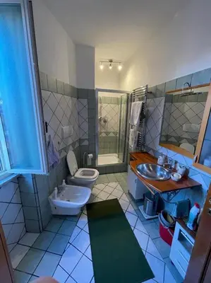 a bathroom with a toilet and a sink at Roma Battistini 66 Apartment, near Vatican City in Rome