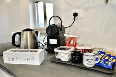 a kitchen counter with a coffee maker and food at White Mary House for two people in Rome