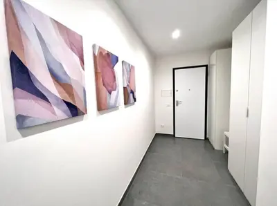 a hallway with three paintings on the wall at White Mary House for two people in Rome
