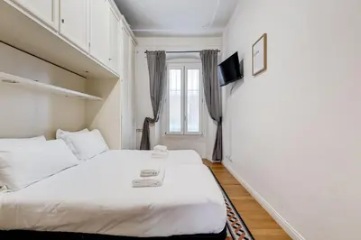 a bedroom with a bed and a window at Salotto Trastevere in Rome