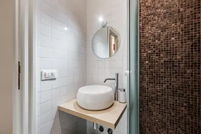 a bathroom with a white sink and a mirror at Salotto Trastevere in Rome