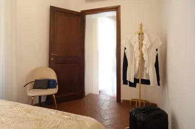 a bedroom with a closet with a shirt hanging on a wall at Campo de Fiori Charming Accommodation in Rome