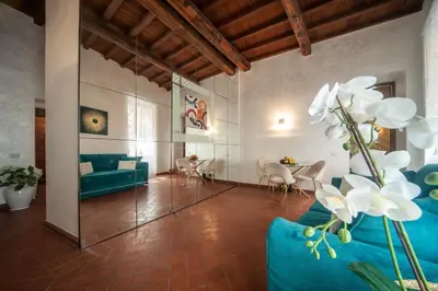 a living room with a blue couch and a table at Campo de Fiori Charming Accommodation in Rome