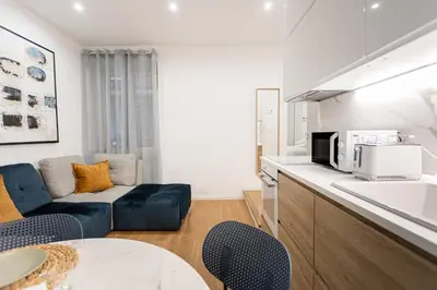 a living room with a couch and a kitchen at Residenza Lungotevere dei Mellini in Rome