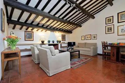a living room with white furniture and a wooden ceiling at Benedetta21 in Rome