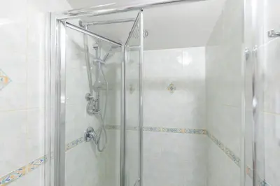 a shower with a glass door in a bathroom at AC21 - Panoramic Studio in Rome