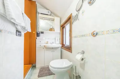 a bathroom with a white toilet and a sink at AC21 - Panoramic Studio in Rome