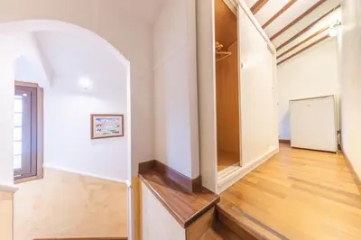 an open hallway with white walls and a wooden floor at AC21 - Panoramic Studio in Rome