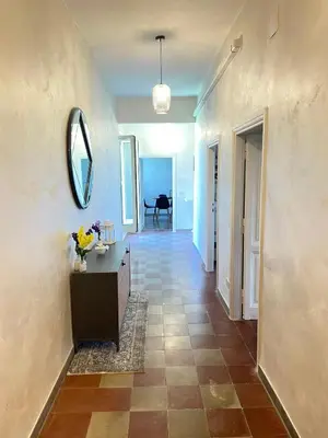 a hallway with a mirror on the wall and a table at Il Nido apartment Roma, Attico ostiense in Rome