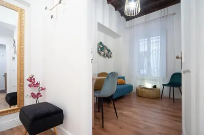 a living room with a blue chair and a table at Pantheon Charming Accommodation in Rome
