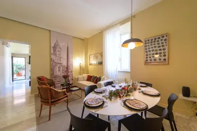 a patio with a table and chairs and flowers at Trevi My Charming Holiday Home, at Trevi Fountain in Rome