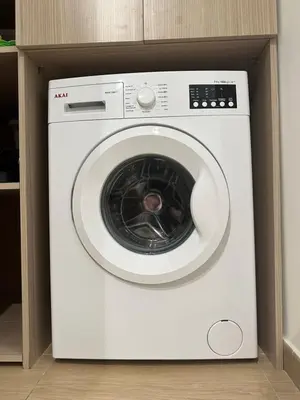 a white washing machine in a box in a kitchen at Betterplace in Rome