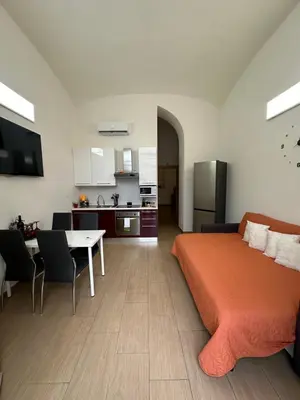a bedroom with a bed and a table and a kitchen at Betterplace in Rome