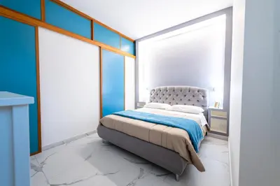 a bedroom with a bed with blue walls at Casa Cate in Rome