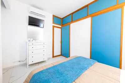 a bedroom with a bed with a blue wall at Casa Cate in Rome