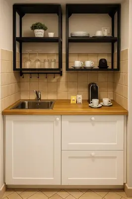 a kitchen with white cabinets and a sink at èROMA - COLOSSEO Apartment in Rome