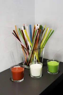 a vase filled with different colored candles on a table at Affittacamere Tiburstation 2 in Rome