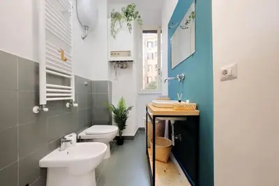 a bathroom with a white toilet and a sink at Gazometro Apartment SelfCheck-in in Rome