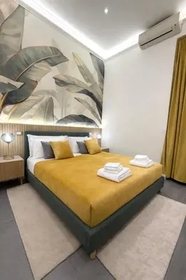 a room with a desk and a tv on the wall at San Pietro Suite - Vatican City in Rome