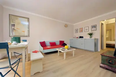 a living room with a red couch and a table at Monti Studio in Rome