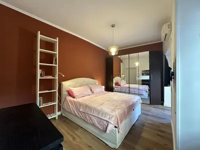 a bedroom with a bed and a mirror at Civico Nove al Colosseo in Rome