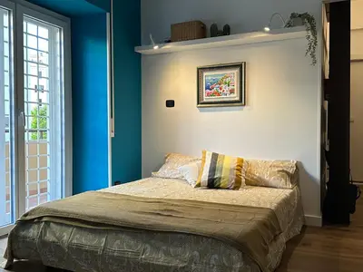a bedroom with blue walls and a bed with pillows at Civico Nove al Colosseo in Rome