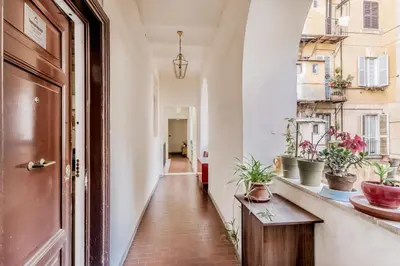 a hallway with potted plants and a door at Trastevere House 24 in Rome