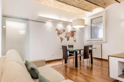 a living room with a couch and a table and chairs at Trastevere House 24 in Rome