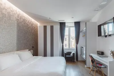 a hotel room with a bed and a desk at The Place Giuliana in Rome