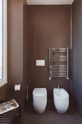 a bathroom with a white toilet and a sink at The Place Giuliana in Rome
