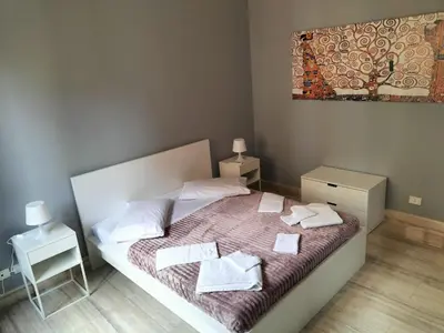 a bedroom with a bed with towels on it at OLD BAKERY TWO BED ROOM APARTMENT in Rome