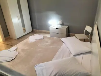 a room with a bed and a dresser and a mirror at OLD BAKERY TWO BED ROOM APARTMENT in Rome