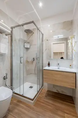 a bathroom with a shower and a sink in a room at Belltower Elegans Guest House in Rome