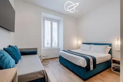 a bedroom with a bed with two lights on at Belltower Elegans Guest House in Rome