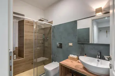 a bathroom with a sink and a toilet and a shower at Kira Luxury Apartment with terrace in Rome
