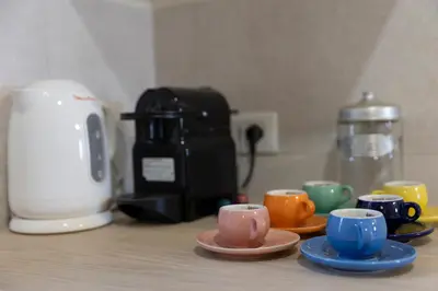 a group of cups and saucers on a kitchen counter at A due passi dal Colosseo in Rome