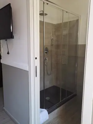 a shower with a glass door in a bathroom at I love Colosseo in Rome