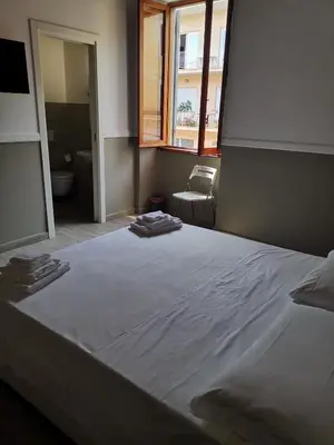 a large bed in a room with a window at I love Colosseo in Rome
