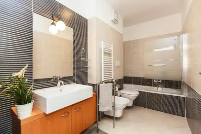 a bathroom with a sink and a toilet and a mirror at Boutique Domus River Terrace in Rome