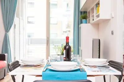 a dining room table with a bottle of wine on it at Boutique Domus River Terrace in Rome