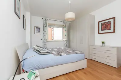 a bedroom with a bed and a dresser and a window at Boutique Domus River Terrace in Rome