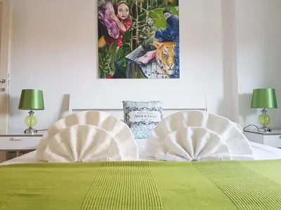 two white chairs sitting on top of a bed at Boutique Domus River Terrace in Rome