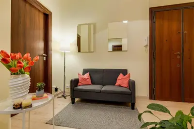 a living room with a chair and a table at Italia Room vicino Stazione Termini in Rome