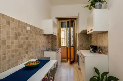 a kitchen with a bowl of fruit on a counter at Italia Room vicino Stazione Termini in Rome