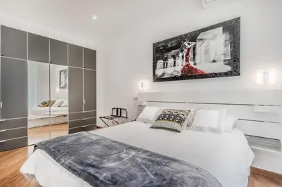 a bedroom with a white bed and a mirror at Sweethome Marconi in Rome