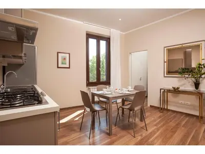 a kitchen and dining room with a table and chairs at Window On Rome in Rome