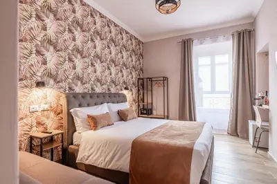 a bedroom with a bed and a couch and a wall at Affittacamere Casalí in Rome