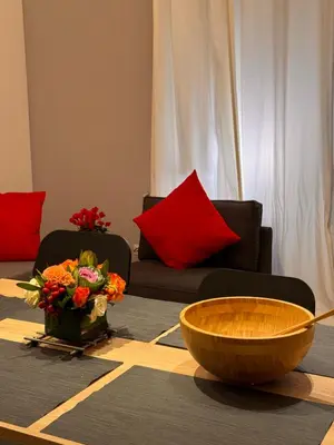 a living room with two couches and a bowl of flowers at GetRoma apartment Vatican Museum in Rome